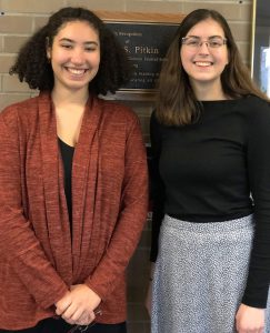 Two students standing next to one another