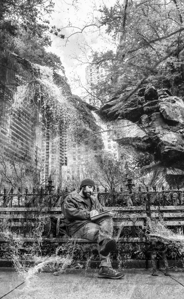 A black and white photo of a man sitting on a bench with a hat on