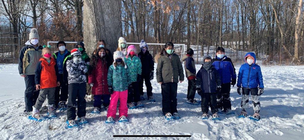 Third grade students wearing snowshoes