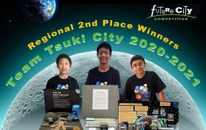 Three students smiling with their future city projects about living on the moon in front of them
