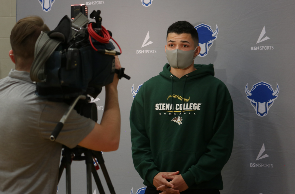student athlete being interviewed by TV cameraman