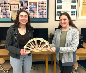 Two students holding their bridge they made