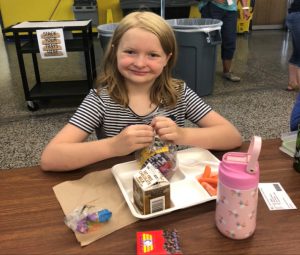 Student at cafeteria table with school lunch tray