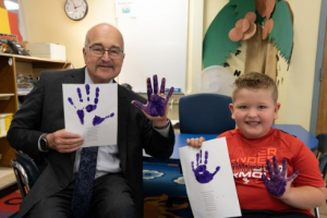 superintendent corr participates in a handprint project with students