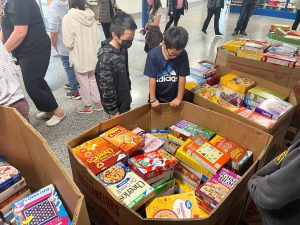 students check out the pallets of cereal boxes donated