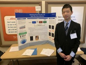 Student researcher standing at tri-fold display at RPI -hosted Science Fair
