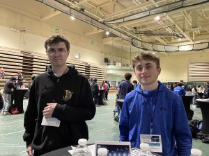 Two students from Junior Achievement stand inside Hudson Valley Community College