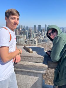 two students in Canada with city skyline behind them.