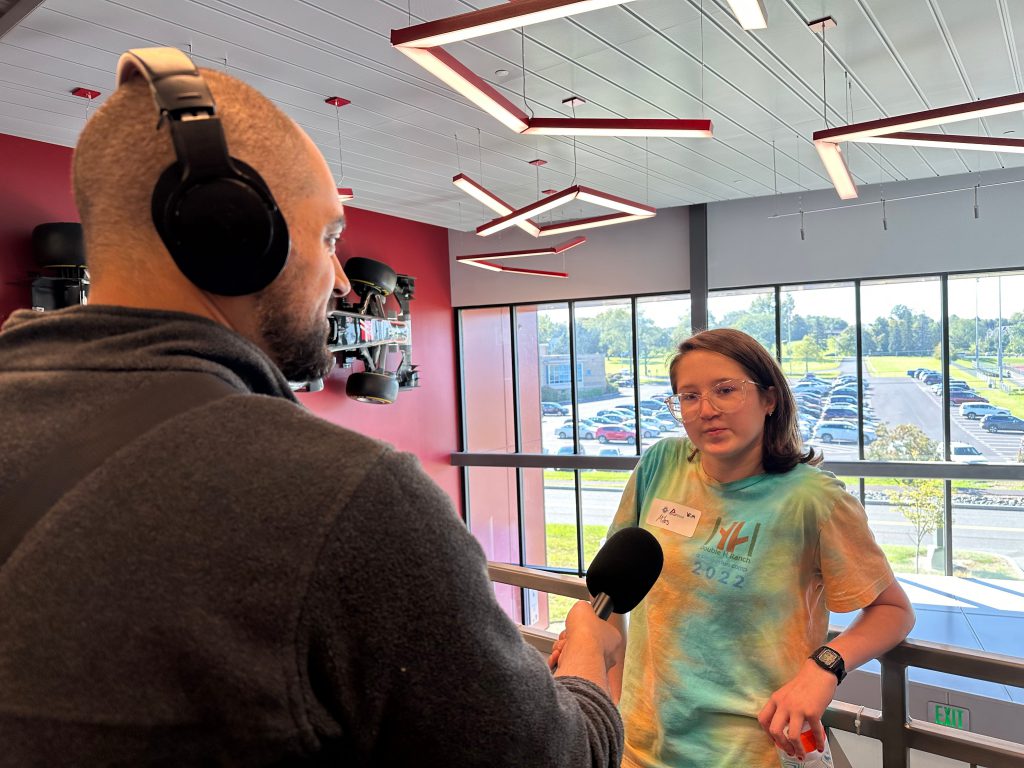 A third student is interviewed as part of the event.