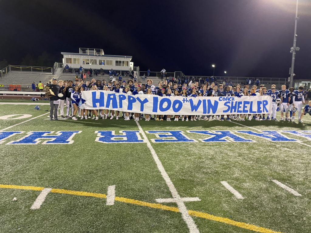 Coach Sheeler and the Shaker football team and cheerleaders celebrating the Colonie Cup victory and Sheeler's 100th career win.