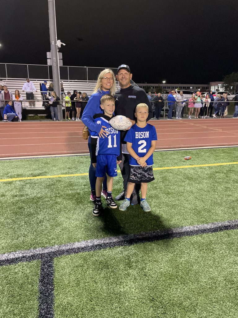Shaker football coach Greg Sheeler and his family after the 100th win of his career.