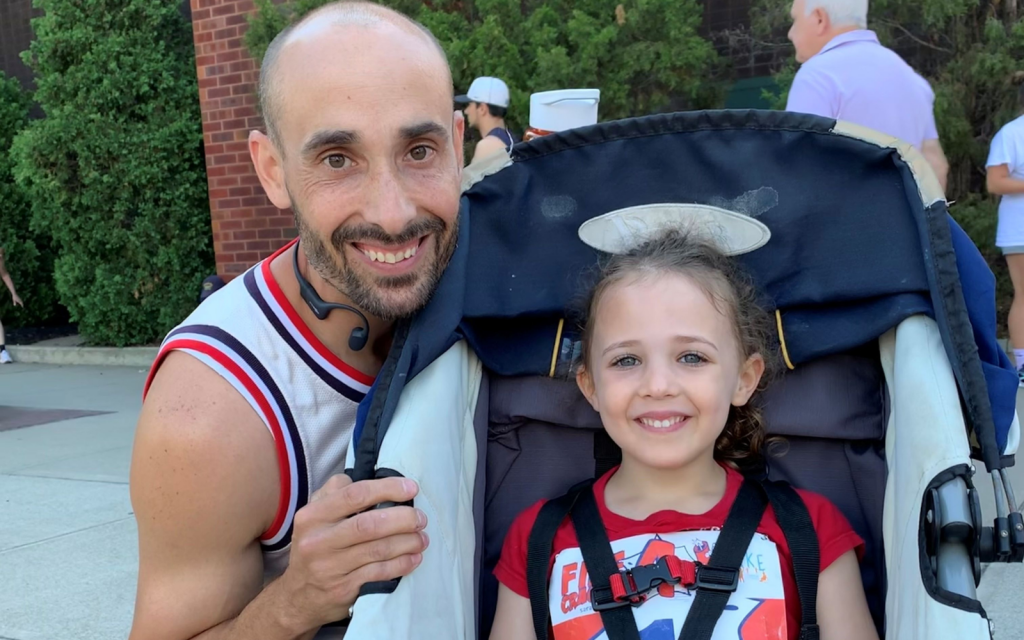 An image of Forts Ferry PE teacher Chris Marsh and a young girl in a stroller posing for a photo.