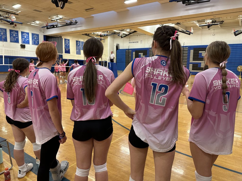 An image of the back of the pink Shaker jerseys being worn at the volleyball game.