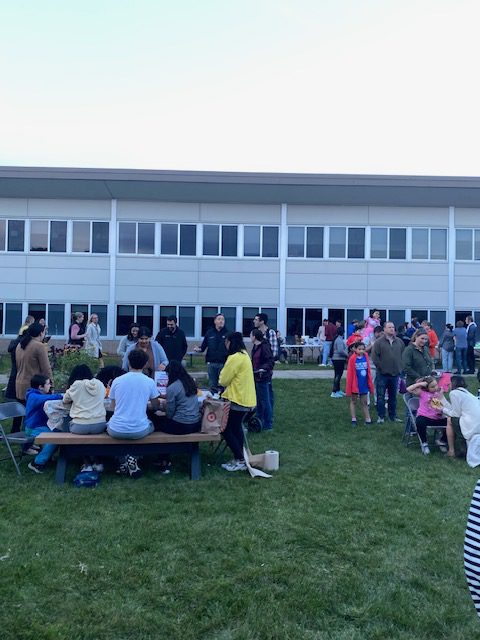 An image of groups of people doing activities at tables.