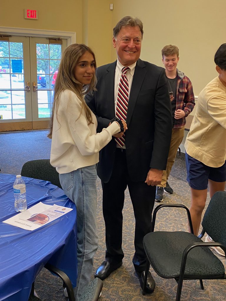 An image of a student meeting Colonie Town Supervisor Peter Crummey.