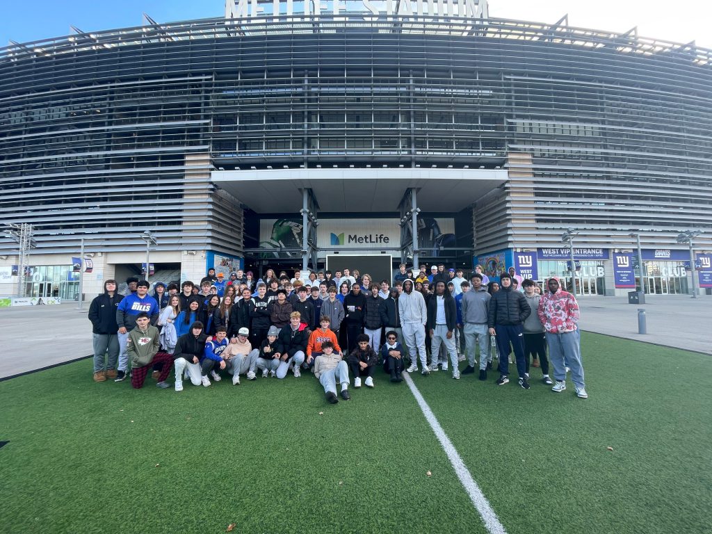 An image of a group of Shaker students posing outside of MetLife Stadium.