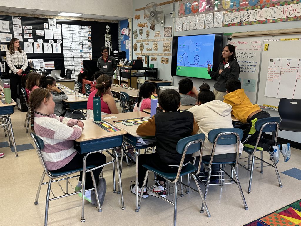 An image of RPI students at the front of a third grade classroom teaching a lesson.