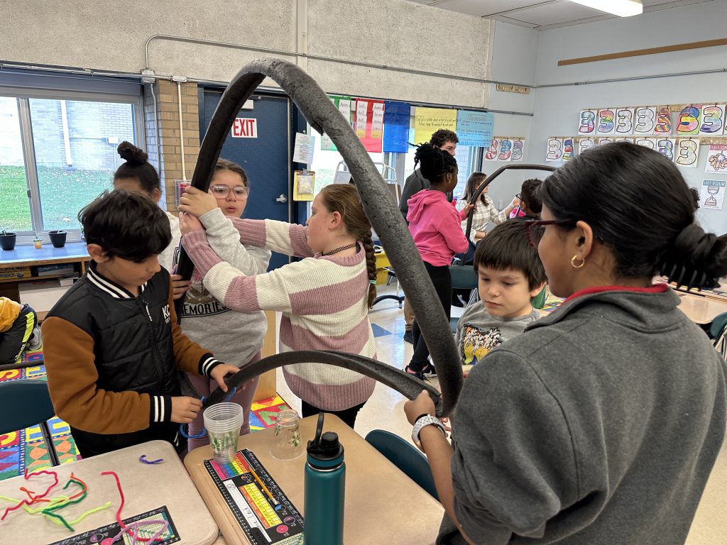An image of a group of third grade students building their rollercoaster.