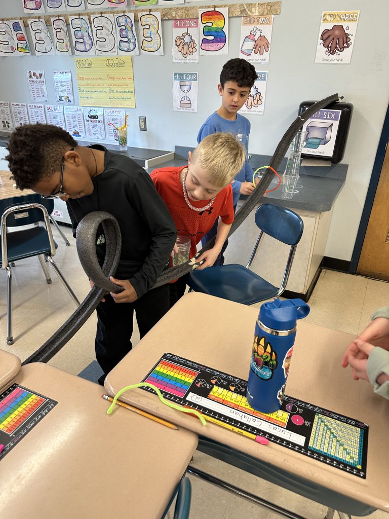 An image of students perfecting the loop in their rollercoaster.