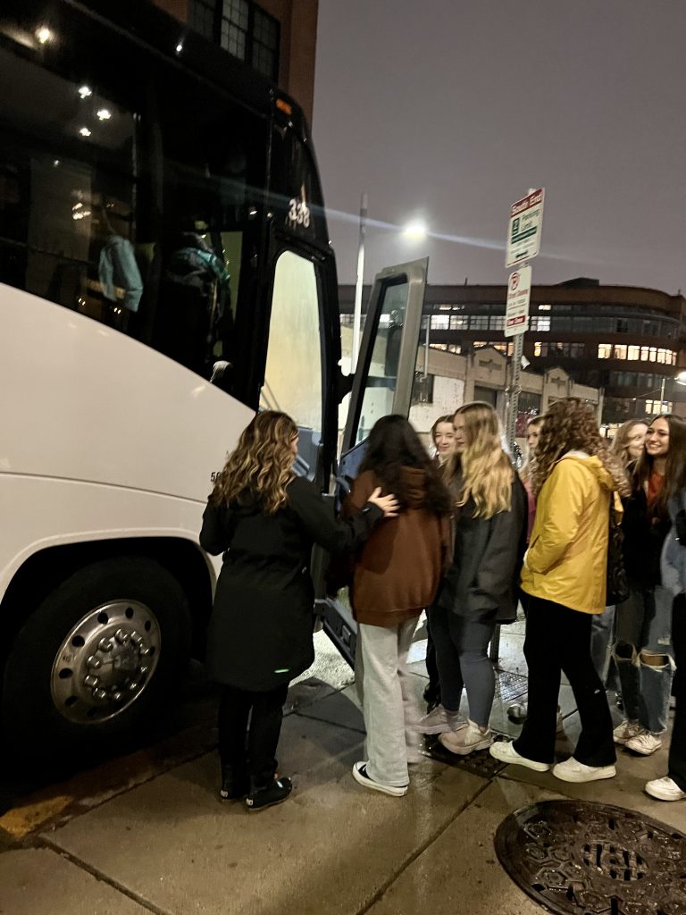 An image of a group of art students ready to board a bus.
