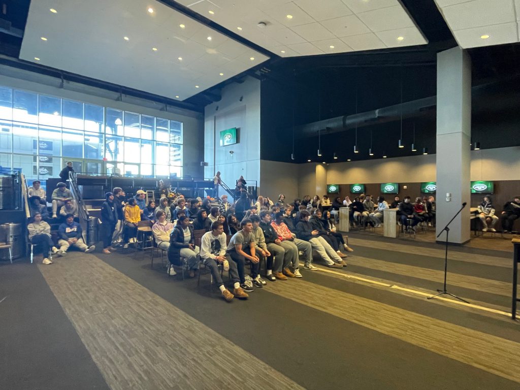 An image of students seated and listening to various speakers.