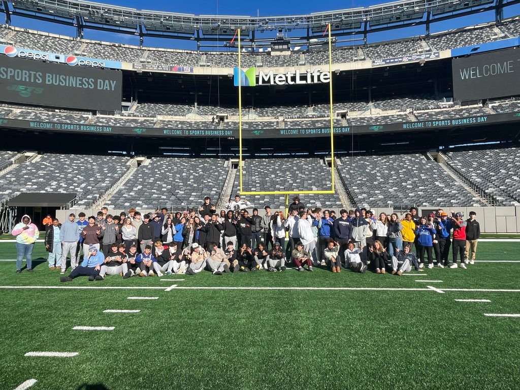 An image of the group of Shaker students posing on the field at MetLife Stadium.