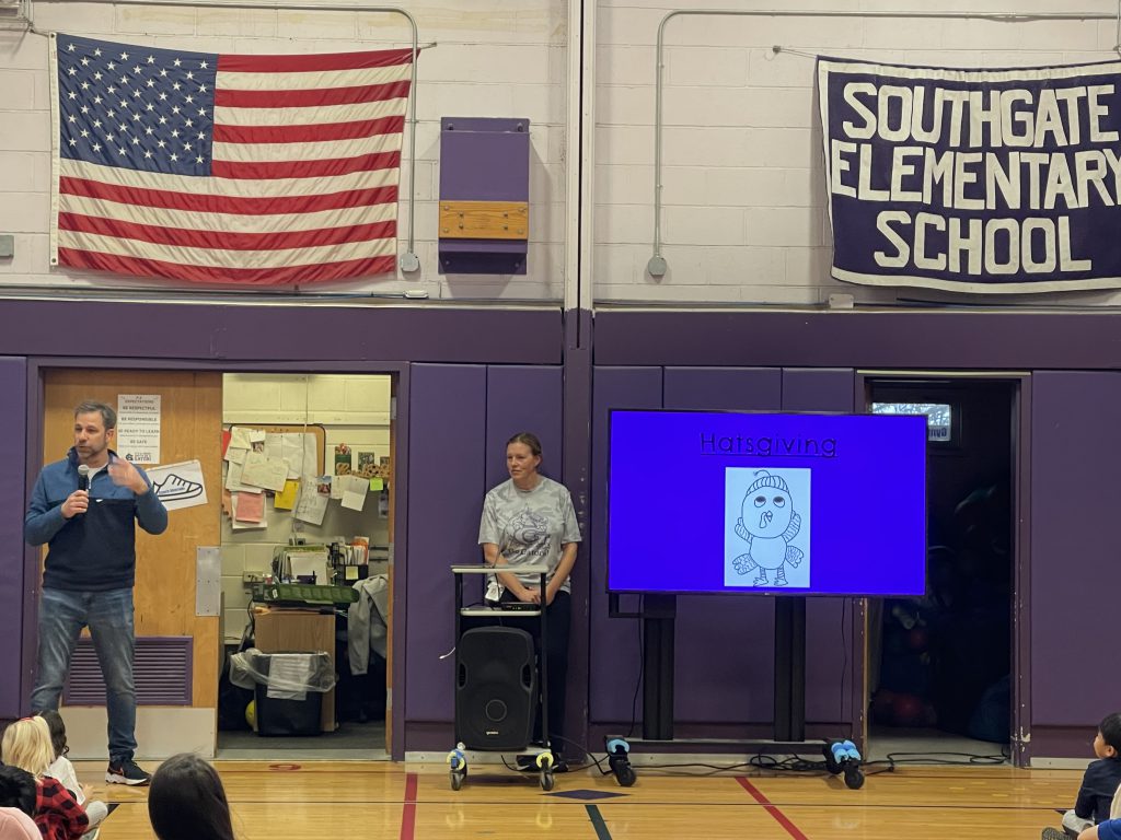 An image of presenter Jeff Wernick standing at the front of the gym along with a Southgate coach.