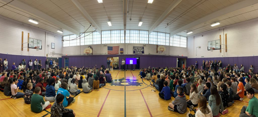 A wide image of the Southgate gym full of students.