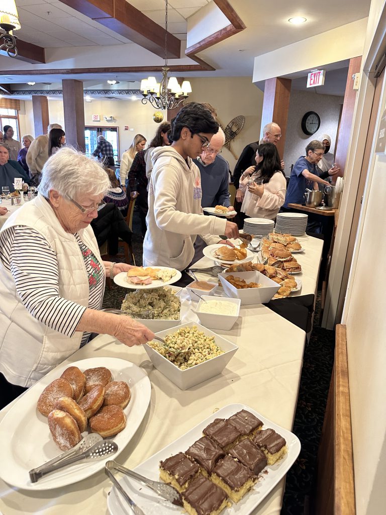 An image of people at a lunch buffet line