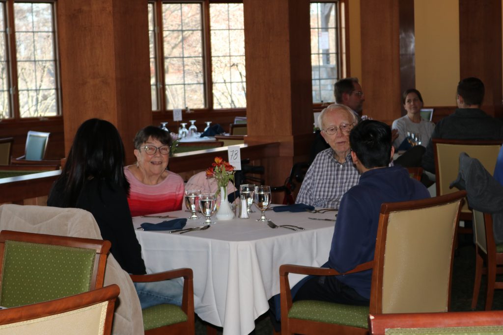 An image of an older couple talking with Shaker Students