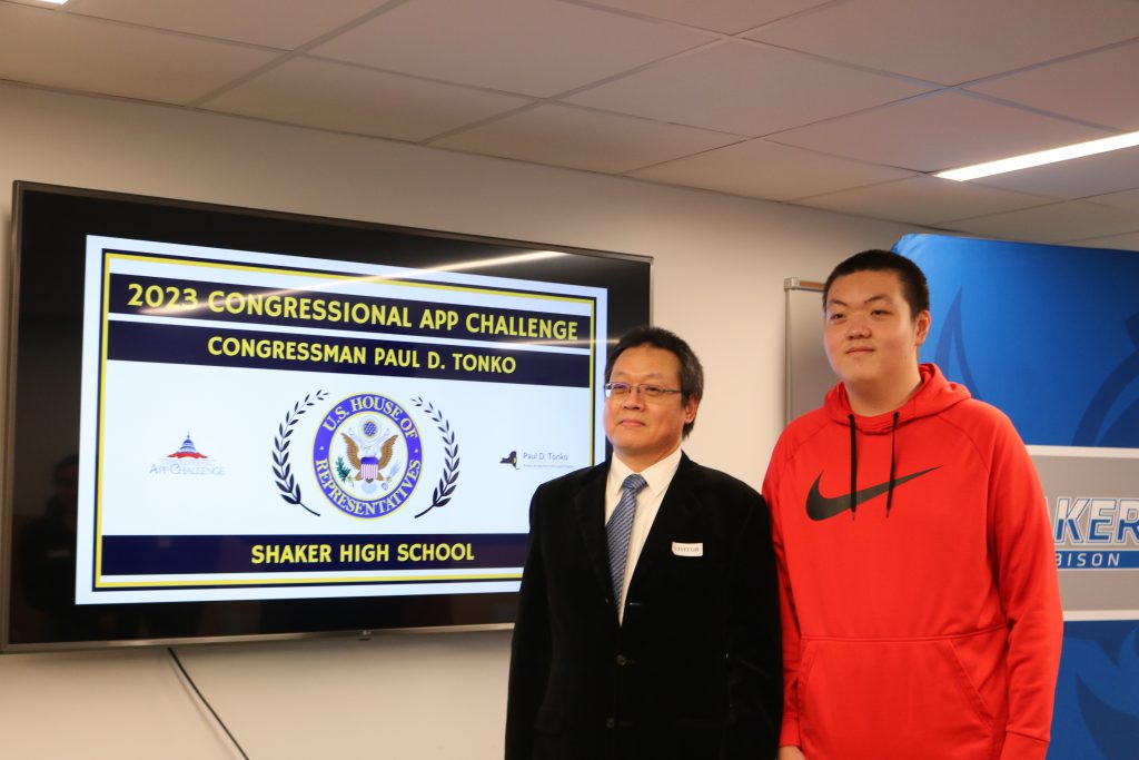 An image of Michael Tong and his father posing.
