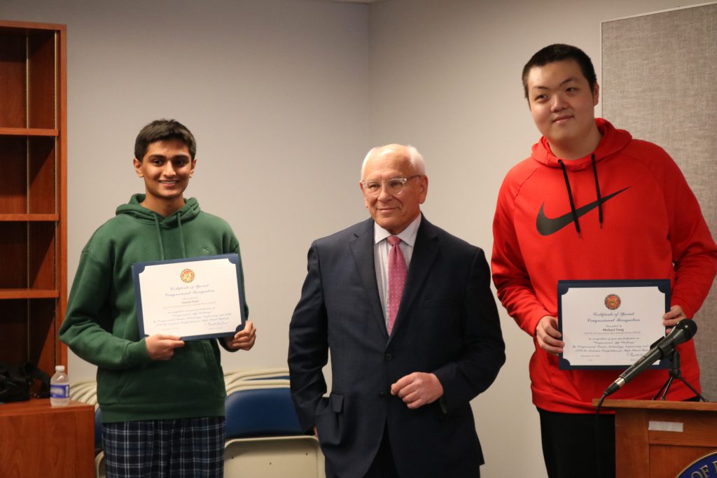 An image of two Shaker student winners receiving their awards from Congressman Paul Tonko.