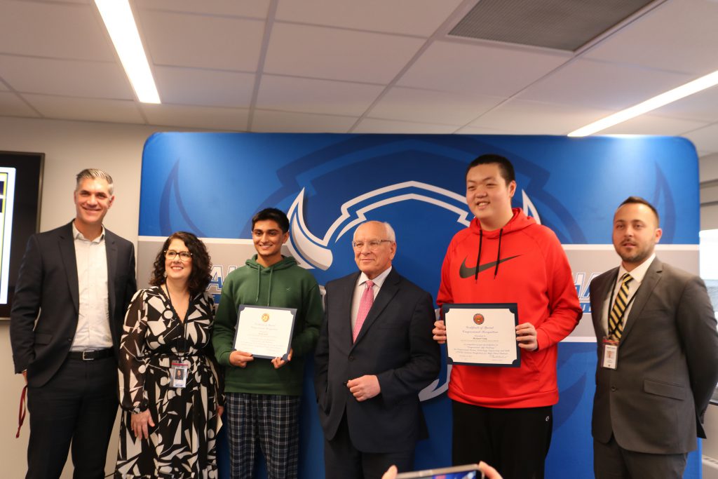 An image of two of the student winners along with Congressman Paul Tonko, Superintendent Kathleen Skeals, Principal Marcus Puccioni and Board member Nick Compromski.
