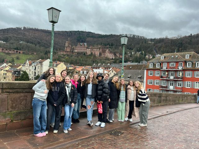 An image of students posing on a sidewalk in Germany.